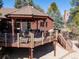 Rear view of the home featuring an outdoor deck with gazebo and stairs to lower patio at 7570 Windford, Parker, CO 80134