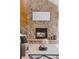 Close-up of a grand stone fireplace with a modern insert and stylish decor at 7570 Windford, Parker, CO 80134