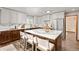 Spacious kitchen featuring an island with seating, stainless appliances, and two-tone cabinetry at 7570 Windford, Parker, CO 80134