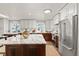 Bright kitchen featuring an island with quartz countertop, stainless appliances, and white cabinetry at 7570 Windford, Parker, CO 80134