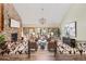 Bright living room with a stone fireplace, large windows, and elegant decor at 7570 Windford, Parker, CO 80134