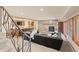 Spacious living room with stone fireplace, bar, built-ins, neutral carpet and large comfortable seating area at 7570 Windford, Parker, CO 80134