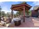 Gazebo sitting area with comfortable seating around a cozy fire pit at 7570 Windford, Parker, CO 80134