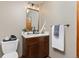 Stylish powder room with marble vanity, modern fixtures, and tasteful decor at 7570 Windford, Parker, CO 80134