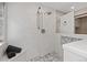Spa-like shower with marble tiling, multiple showerheads, and a built-in bench at 7570 Windford, Parker, CO 80134