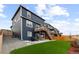 Backyard featuring artificial turf, a patio with outdoor seating, and a wooden deck with stairs at 17969 Sky Pilot Ave, Parker, CO 80134