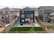 Aerial backyard view with artificial turf, patio seating, wooden deck and stairs and privacy fence at 17969 Sky Pilot Ave, Parker, CO 80134