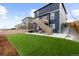 Expansive backyard featuring lush green lawn, patio perfect for entertaining, and convenient stair access at 17969 Sky Pilot Ave, Parker, CO 80134