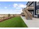 Spacious backyard with new artificial turf and a wooden staircase leading to a deck at 17969 Sky Pilot Ave, Parker, CO 80134