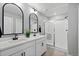 Well-lit bathroom featuring double sinks, modern fixtures, and a glass-enclosed shower for a spa-like experience at 17969 Sky Pilot Ave, Parker, CO 80134
