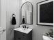 Modern bathroom featuring a vanity with a dark base and brushed chrome fixtures at 17969 Sky Pilot Ave, Parker, CO 80134