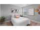 Well-lit bedroom featuring a window, comfortable bedding, and stylish decor for a relaxing and personal space at 17969 Sky Pilot Ave, Parker, CO 80134