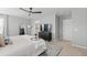 Primary bedroom featuring a ceiling fan, dark wood furniture, and neutral decor at 17969 Sky Pilot Ave, Parker, CO 80134
