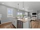 Bright, open kitchen featuring an island and views from large windows at 17969 Sky Pilot Ave, Parker, CO 80134