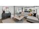 Bright living room featuring a comfortable sofa, modern decor, and hardwood flooring at 17969 Sky Pilot Ave, Parker, CO 80134