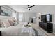 Comfortable main bedroom with a ceiling fan, large windows, and an accent mirror creating a relaxing retreat at 17969 Sky Pilot Ave, Parker, CO 80134