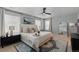Serene main bedroom with a ceiling fan, plush bedding, and large windows creating a relaxing retreat at 17969 Sky Pilot Ave, Parker, CO 80134