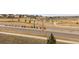 Street view of neighborhood, sidewalks, manicured lawns, with amenities in the distance at 17969 Sky Pilot Ave, Parker, CO 80134