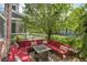 Cozy backyard patio features a red sectional couch, fire pit, and well-manicured landscaping at 8056 E 35Th Ave, Denver, CO 80238