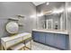 Glamorous bathroom with double vanity, modern lighting fixtures, and a dedicated makeup area, offers lots of storage space at 8056 E 35Th Ave, Denver, CO 80238