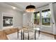 Bright dining room features hardwood floors, contemporary chandelier, and large windows at 8056 E 35Th Ave, Denver, CO 80238