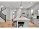 Bright kitchen with a large center island featuring barstool seating and modern pendant lighting at 8056 E 35Th Ave, Denver, CO 80238