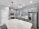 Modern kitchen with gray cabinets, stainless steel appliances, and a large center island at 8056 E 35Th Ave, Denver, CO 80238