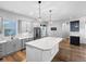 Bright kitchen with large island, stainless steel appliances, and decorative pendant lighting at 8056 E 35Th Ave, Denver, CO 80238