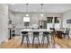 Spacious kitchen with center island, seating, modern appliances, and an adjacent dining area at 8056 E 35Th Ave, Denver, CO 80238