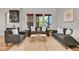 Bright living room offers modern furniture and large windows bringing natural light and a unique textured accent wall at 8056 E 35Th Ave, Denver, CO 80238
