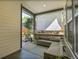Relaxing covered patio with comfortable wicker seating, offering a serene space for outdoor enjoyment and relaxation at 8056 E 35Th Ave, Denver, CO 80238