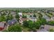 Aerial view of a neighborhood with pond and lush greenery at 7597 Bison Ct, Littleton, CO 80125
