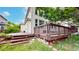 View of a tiered wooden deck featuring railing with steps leading down to a grassy yard at 7597 Bison Ct, Littleton, CO 80125