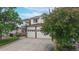 Two-story home featuring a three-car garage and manicured landscaping at 7597 Bison Ct, Littleton, CO 80125