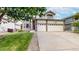 Charming two-story home with a well-maintained lawn and an attached three-car garage, enhancing curb appeal at 7597 Bison Ct, Littleton, CO 80125