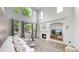 Bright living room with vaulted ceilings, large windows, and a cozy fireplace at 7597 Bison Ct, Littleton, CO 80125