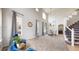 Spacious living room featuring tall ceilings, modern decor, and a staircase leading to the upper level at 7597 Bison Ct, Littleton, CO 80125