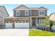 Beautiful two-story home featuring a stone facade, gray siding, attached two-car garage and a well-maintained lawn at 4202 Sandstone Dr, Mead, CO 80504