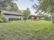 Expansive backyard with lush green lawn and a covered patio at 3961 S Clermont St, Cherry Hills Village, CO 80113