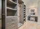Walk-in closet with built-in shelving, drawers, and a vanity area at 3961 S Clermont St, Cherry Hills Village, CO 80113