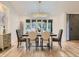Formal dining room featuring large windows, elegant chandelier, and hardwood floors at 3961 S Clermont St, Cherry Hills Village, CO 80113