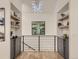 Hallway featuring hardwood floors, custom built-ins, and a modern chandelier at 3961 S Clermont St, Cherry Hills Village, CO 80113