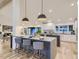 Open kitchen featuring an island with seating, modern appliances, and hardwood floors at 3961 S Clermont St, Cherry Hills Village, CO 80113