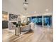 Bright living room with vaulted ceilings, fireplace, and sliding glass doors to the backyard at 3961 S Clermont St, Cherry Hills Village, CO 80113