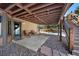Inviting back patio with seating area, stone landscaping, and direct access to backyard and stairs at 34 Amaranth Dr, Littleton, CO 80127