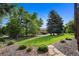 Expansive backyard featuring lush green grass, mature trees, and professional landscaping, creating a serene outdoor space at 34 Amaranth Dr, Littleton, CO 80127