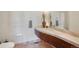 Modern bathroom with custom curved wood vanity, vessel sink, and decorative accents at 34 Amaranth Dr, Littleton, CO 80127
