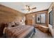 Stylish bedroom with rustic wood accent wall, ceiling fan, and Southwestern-inspired bedding for a warm ambiance at 34 Amaranth Dr, Littleton, CO 80127