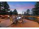 Enjoy outdoor dining and entertaining on this deck, surrounded by lush trees, perfect for sunset views and gatherings at 34 Amaranth Dr, Littleton, CO 80127