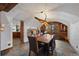 Cozy dining room features a rustic table, barrel wine racks, unique lighting, and views into kitchen at 34 Amaranth Dr, Littleton, CO 80127